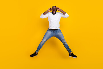 Fototapeta na wymiar Full size photo of overjoyed astonished guy hands touch glasses open mouth isolated on yellow color background