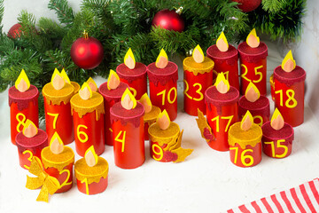 Handmade advent calendar with toilet paper tubes. Christmas candle craft. Seasonal eco activity for kids. Reuse concept