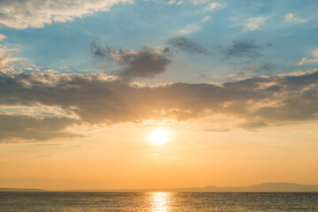 Evening sky with dramatic clouds over the sea. Dramatic sunset over the sea