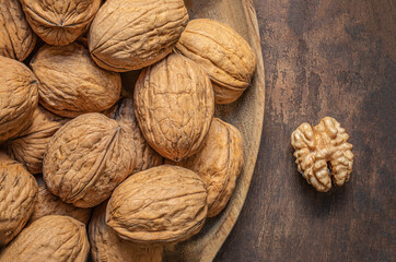 Walnuts on dark vintage table. Walnuts kernels with green leaves. Copyspace.