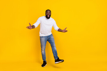Fototapeta na wymiar Full body photo of satisfied carefree person arms palms enjoy free time toothy smile isolated on yellow color background
