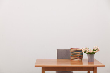 desk with flowers and books for learning