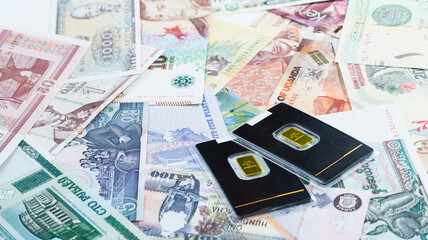 Various currencies. Banknotes, money, gold bars from different countries. Diversification of the investment portfolio. Investing in financial instruments, saving. Inflation, exchange rates.