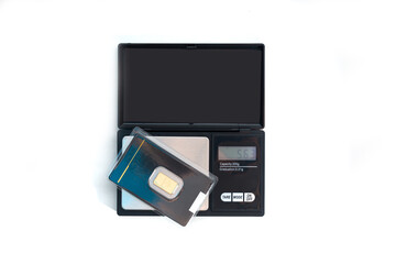 Jewelery weight with gold bars. Concept of weighing gold, gemstones. Work in jewelry, valuation of personal goods.