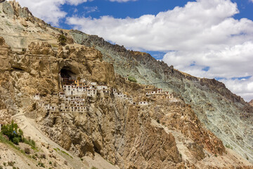 The ancient Tibetan Buddhist Phuktal monastery of on a steep rocky hillside in the Zanskar region in Ladakh in the Indian himalaya. - obrazy, fototapety, plakaty
