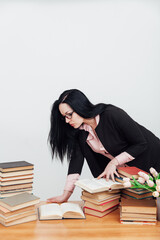 female teacher at a table with books for teaching