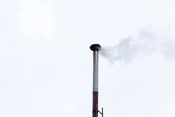 chimneys on the roof of a building in winter