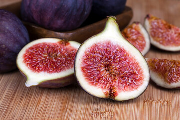 ripe purple figs on a wooden table
