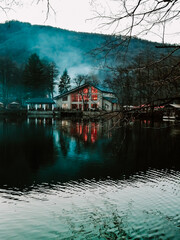 Fototapeta premium A house with a haze, by a blue lake. North Caucasus. Lake Tserik-Kel.