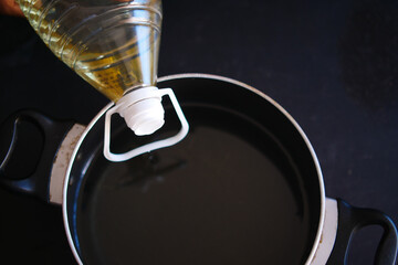  pouring sunflower oil in a pan 