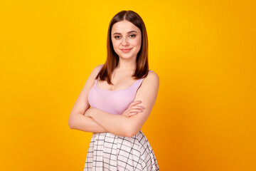 Profile side photo of young adorable woman confident crossed hands isolated over yellow color background