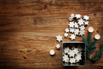 Obraz na płótnie Canvas Homemade cinnamon stars on brown vintage wood. Top view backgrond with christmas cookies and space for text.