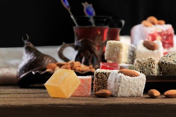 Arabic traditional sweets and berry with tea on plate