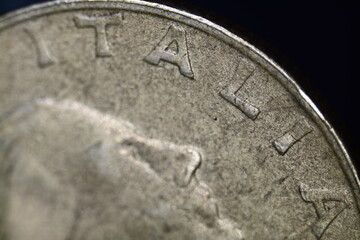 Word Italia written on Italian lira coin in close-up.