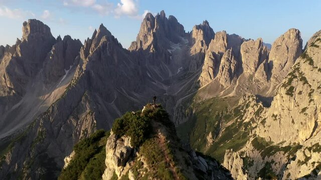 Man watching sunset standing at top of the mountain in Tre Come di Lavaredo, Dolomites