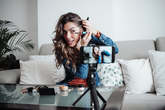 Influencer applying mascara at home studio