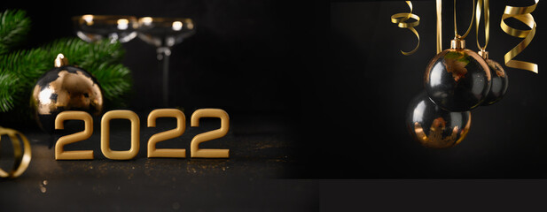 New Year banner with festive composition, luxury gold 2022 number of year , black and gold baubles, Christmas decorations on black background. Xmas greeting card.