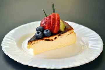 Middle view, Basque Burnt Cheesecake on white plate.