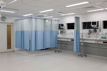 Recovery room in a modern hospital, post-operative recovery, patient bays with curtains