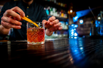 man hand bartender making negroni cocktail in bar