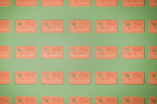 Credit cards arranged side by side on green background
