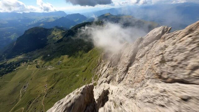 First person view over rocks. Drone view over mountains in Dolomites, Italy. Picturesque Sky over the Odle Group Mountains. Val Gardena. 