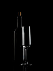 
wine and champagne glass on black background with pouring red wine