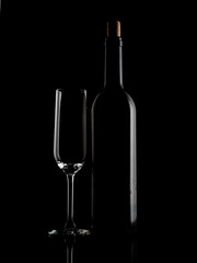 
wine and champagne glass on black background with pouring red wine