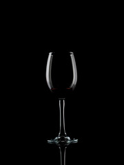 
wine and champagne glass on black background with pouring red wine