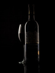 
wine and champagne glass on black background with pouring red wine