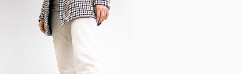 Female in white pants and casual jacket on a white background, studio fashion banner with copy space