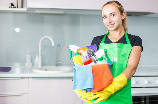 Young Woman Holding Bucket With Group Of Cleaning Supplies For Natural And Environmentally Friendly Cleaning. Household Equipment, Tidying Up, Cleaning Service Concept, Copy Space