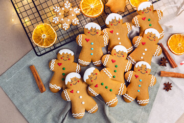 Flat lay composition with delicious homemade Gingerbread Christmas cookies on baking rack and textile napkin. Greeting card. New Year and Christmas.