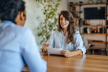 Confident employee, presenting her project to her boss