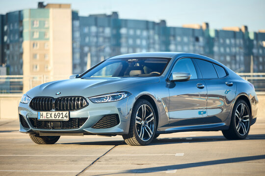 Berlin - October 2021: BMW 8 Series G16 Gran Coupe 840i xDrive M-pack 2021. Left side three quarter view selective focus over urban background under blue sky with copyspace.
