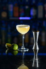 yellow refreshing coctail on a bar desk