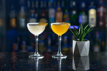 yellow refreshing coctails on a bar desk