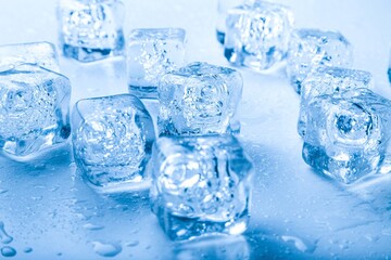 Top view. Ice cubes with water drops scattered on a background.