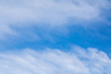 Blue sky background with white clouds.