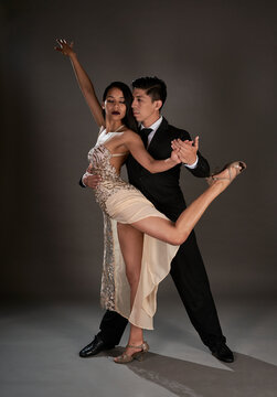 Studio Shoot Latin Woman And Asian Man Dancing Tango Ballroom