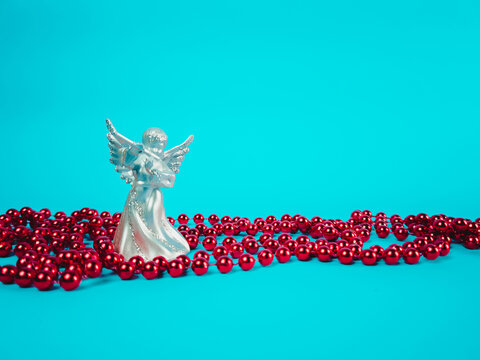 Christmas angel statue with decorations on a blue background