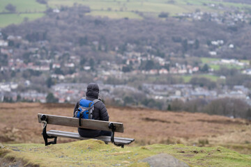 Person sitting on a bench overlooking Yorkshire town