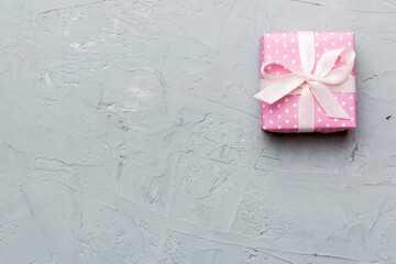 Valentine day composition: red gift box with bow and heart. Christmas present. View from above. Space for text. Holday greeting card