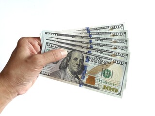 Human hand holding several 100 dollar banknotes on a white background.