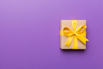 Holiday present box over colored background, top view. Copy space for design