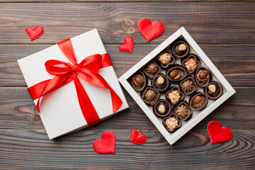 Delicious chocolate pralines in red box for Valentine's Day. Heart shaped box of chocolates top view with copy space
