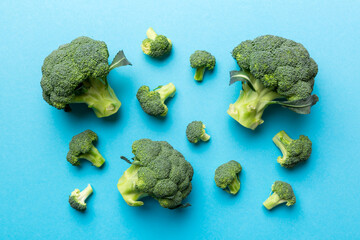 green fresh broccoli background close up on colored table. Vegetables for diet and healthy eating. Organic food