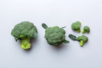 green fresh broccoli background close up on colored table. Vegetables for diet and healthy eating. Organic food