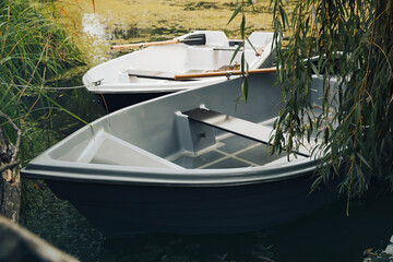 Naklejka na ściany i meble Modern boats with wooden oars on lake