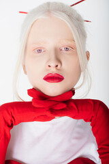 Portrait of albino woman with red lips holding hands in gloves near face isolated on white.